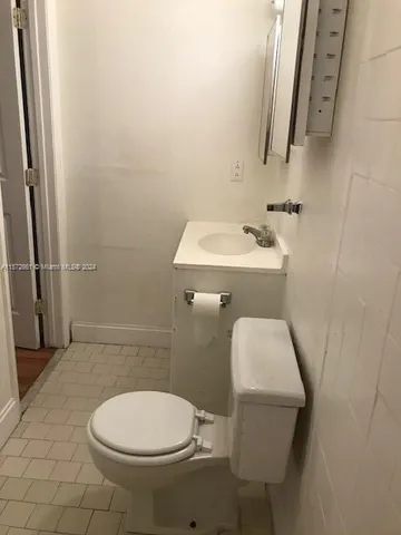 a bathroom with a sink toilet and mirror