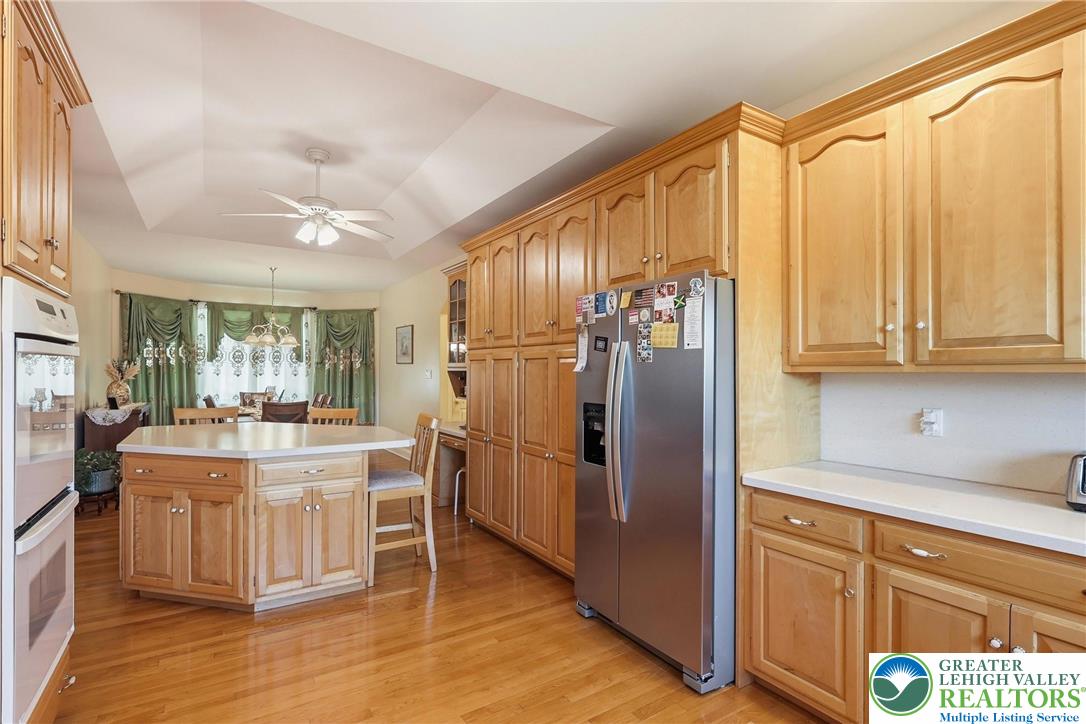 5217 Cider Press Road Schnecksville, PA 18078 - Photo 20 of 54 a kitchen with stainless steel appliances granite countertop a refrigerator and a stove top oven