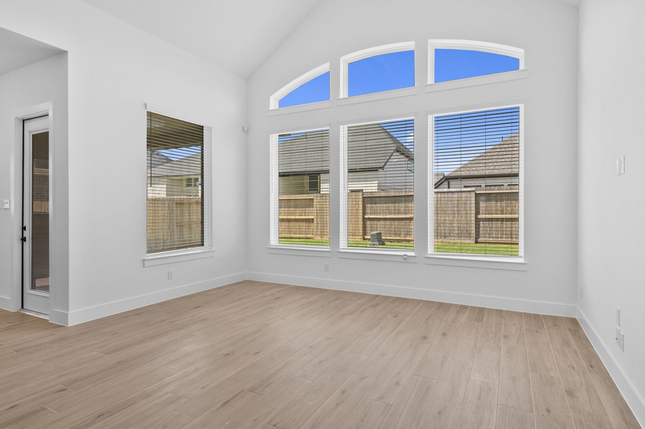 2910 Peach Vly Road Fulshear, TX 77423 - Photo 22 of 35 a view of an empty room with wooden floor and windows