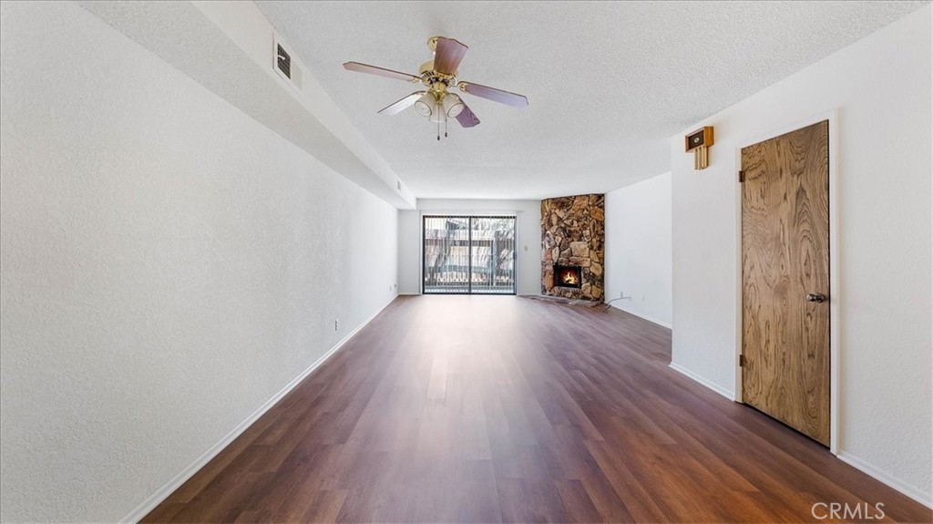 636 East Harvard Road, Unit C Burbank, CA 91501 - Photo 2 of 13 a view of an empty room with wooden floor and a window