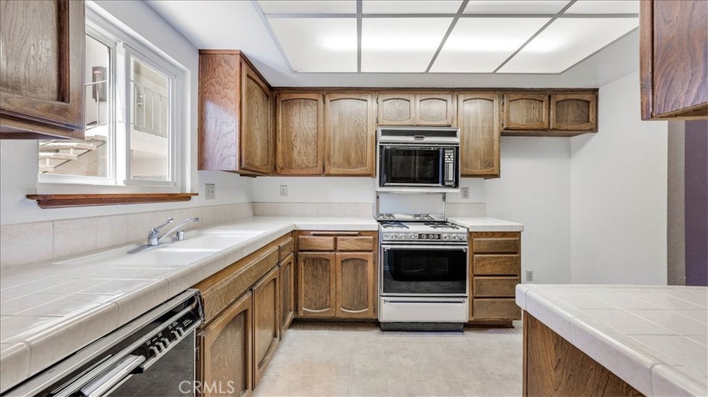 636 East Harvard Road, Unit C Burbank, CA 91501 - Photo 4 of 13 a kitchen with stainless steel appliances granite countertop a stove and a sink
