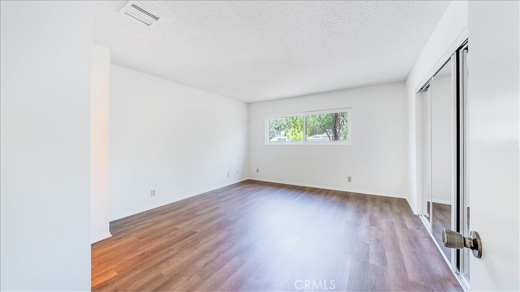 636 East Harvard Road, Unit C Burbank, CA 91501 - Photo 7 of 13 a view of an empty room with wooden floor and a window