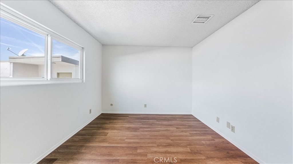 636 East Harvard Road, Unit C Burbank, CA 91501 - Photo 10 of 13 a view of empty room with wooden floor and fan