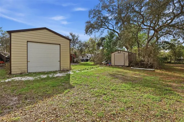 a view of a small house with backyard