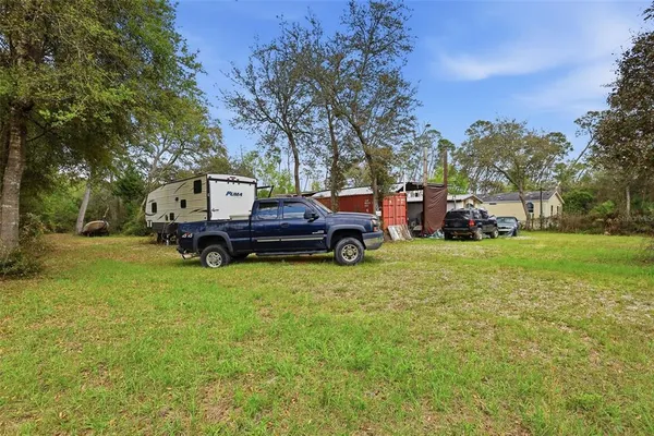 a view of a porch with furniture and a yard