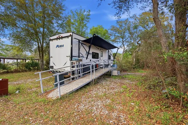a view of a house with backyard and sitting area