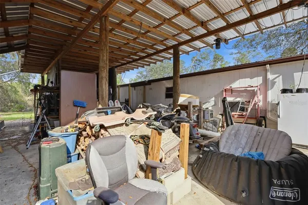 a store room with lots of furniture and clutter