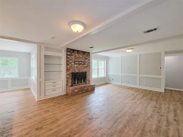 an empty room with furniture and a fireplace