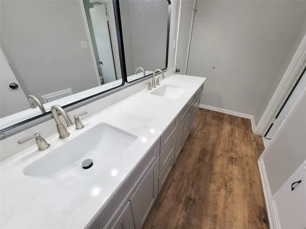a bathroom with a double vanity sink and a mirror