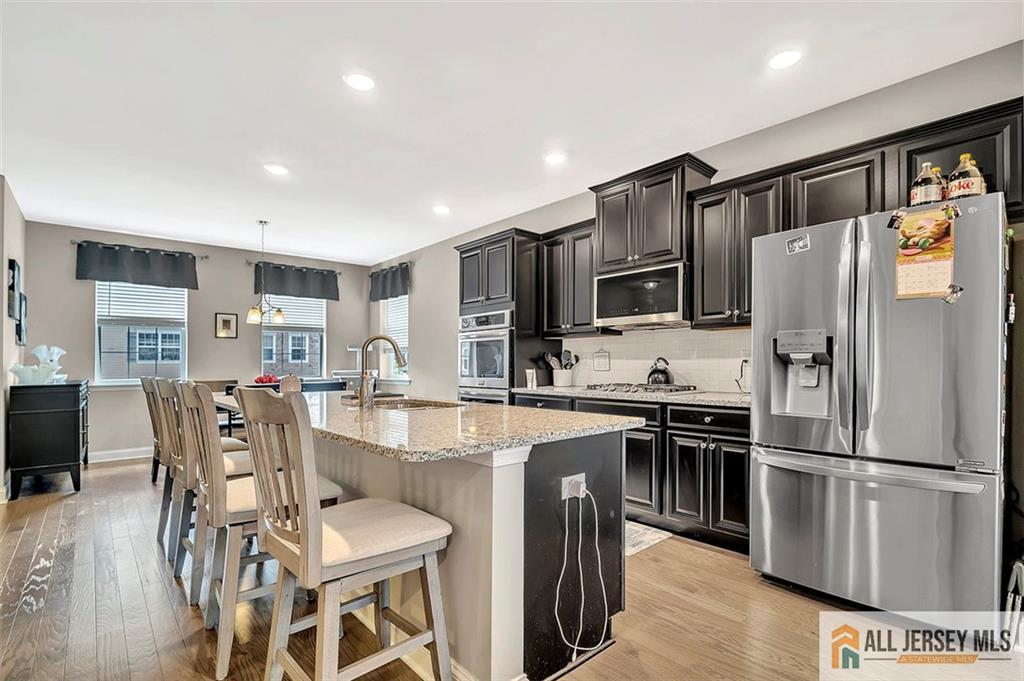 1501 Hights Farm Road South, Unit 1501 Monroe Township, NJ 08831 - Photo 11 of 30 a kitchen with stainless steel appliances a refrigerator stove microwave and cabinets