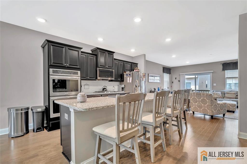 1501 Hights Farm Road South, Unit 1501 Monroe Township, NJ 08831 - Photo 15 of 30 a living room with stainless steel appliances furniture and a kitchen view