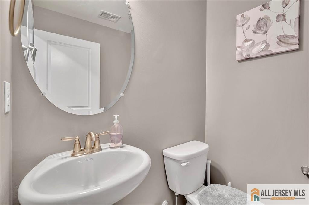 1501 Hights Farm Road South, Unit 1501 Monroe Township, NJ 08831 - Photo 17 of 30 a bathroom with a toilet a sink and a mirror