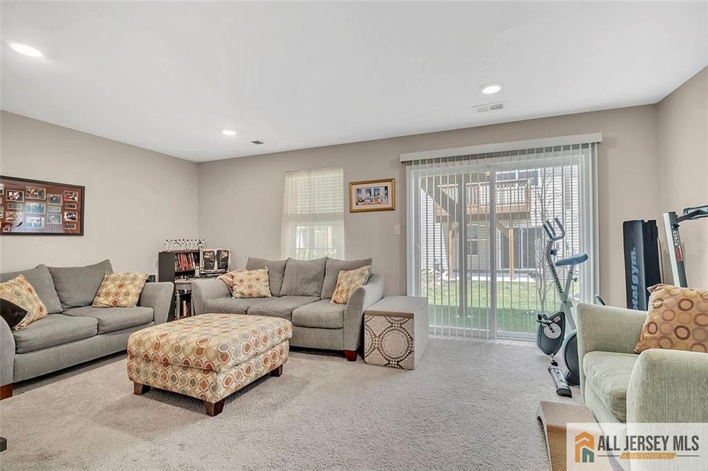 1501 Hights Farm Road South, Unit 1501 Monroe Township, NJ 08831 - Photo 18 of 30 a living room with furniture and a large window