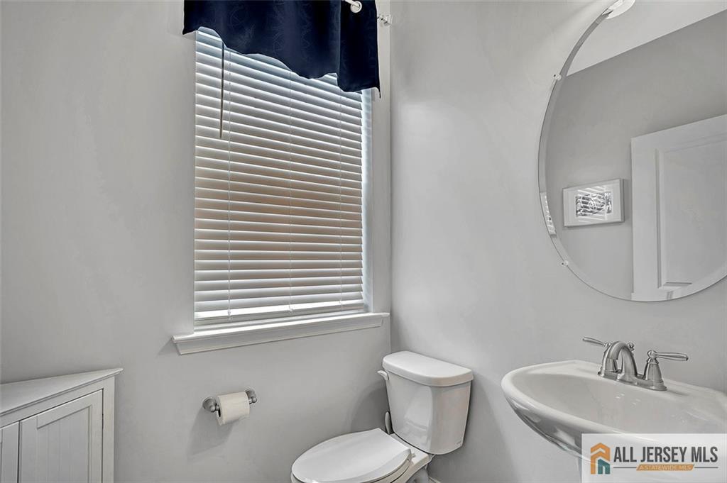 1501 Hights Farm Road South, Unit 1501 Monroe Township, NJ 08831 - Photo 23 of 30 a bathroom with a toilet sink and mirror