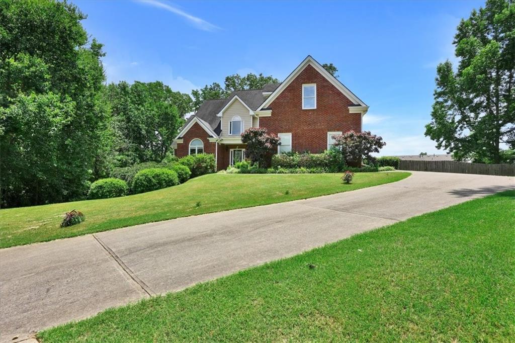 a front view of a house with a yard