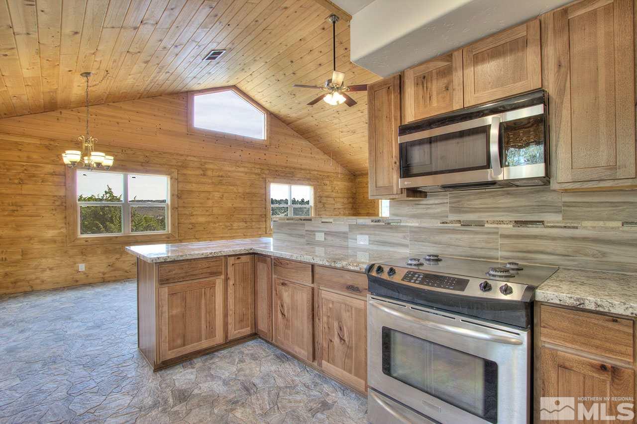 2240 Lousetown Road Reno, NV 89521 - Photo 11 of 25 a kitchen with stainless steel appliances granite countertop a stove and a microwave