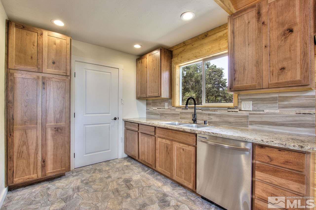 2240 Lousetown Road Reno, NV 89521 - Photo 9 of 25 a kitchen with stainless steel appliances granite countertop a sink and a window