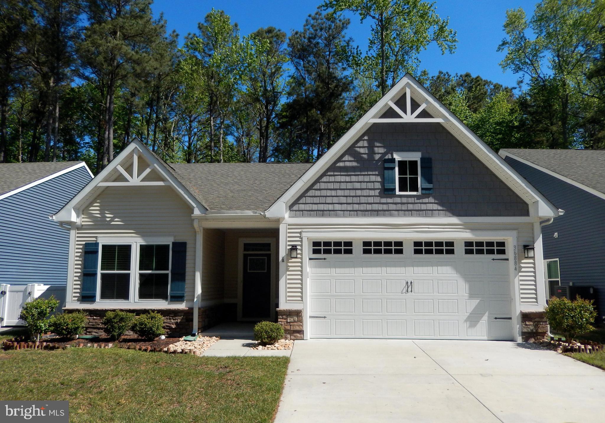 36884 Red Cedar Loop Ocean View, DE 19970 - Photo 1 of 50 a front view of a house with a yard and garage
