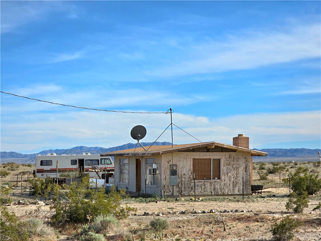 80649 Brown Road Twentynine Palms, CA 92277 - Photo 13 of 15 a front view of a house with a yard