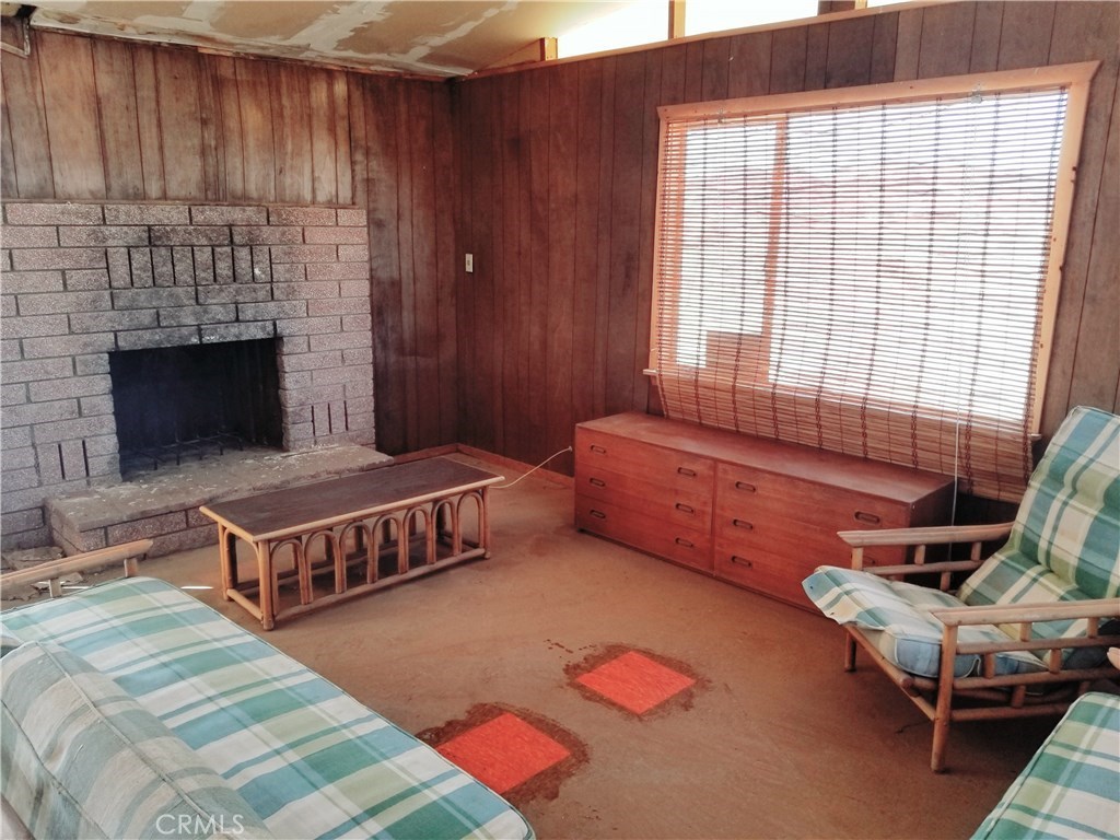 80649 Brown Road Twentynine Palms, CA 92277 - Photo 7 of 15 a bedroom with furniture and a fireplace