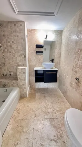 a bathroom with a tub a sink and a toilet