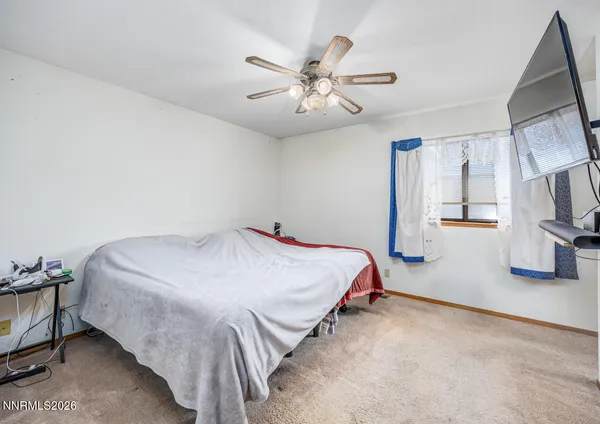 a bed room with a bed and a ceiling fan