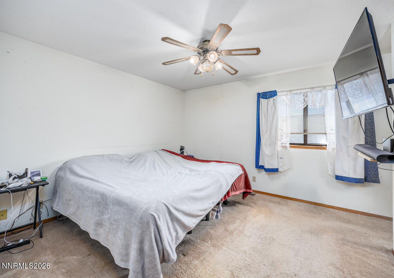 540 Michael Drive Fallon, NV 89406 - Photo 12 of 16 a bed room with a bed and a ceiling fan
