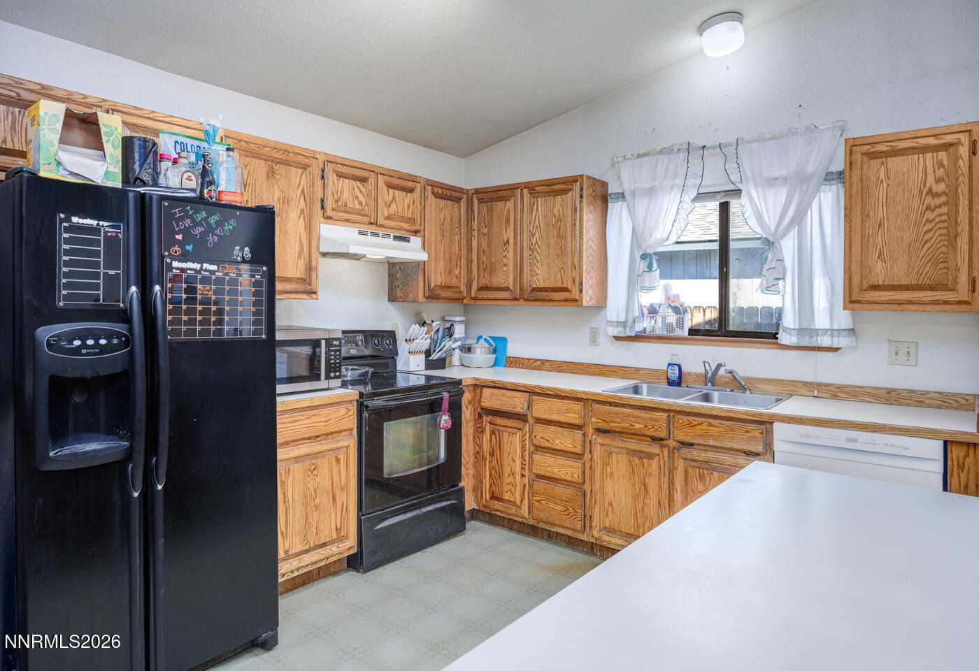 540 Michael Drive Fallon, NV 89406 - Photo 5 of 16 a kitchen with stainless steel appliances granite countertop a stove a sink and a refrigerator