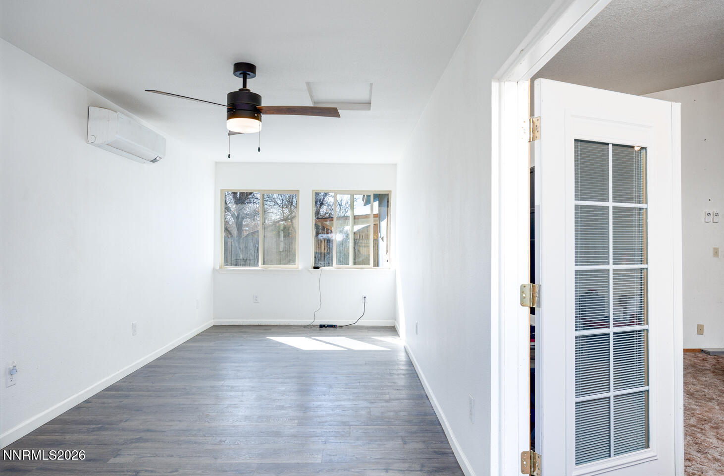 540 Michael Drive Fallon, NV 89406 - Photo 7 of 16 a view of an empty room with wooden floor and a window