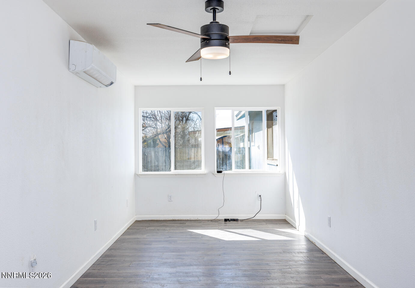 540 Michael Drive Fallon, NV 89406 - Photo 8 of 16 an empty room with wooden floor chandelier fan and windows