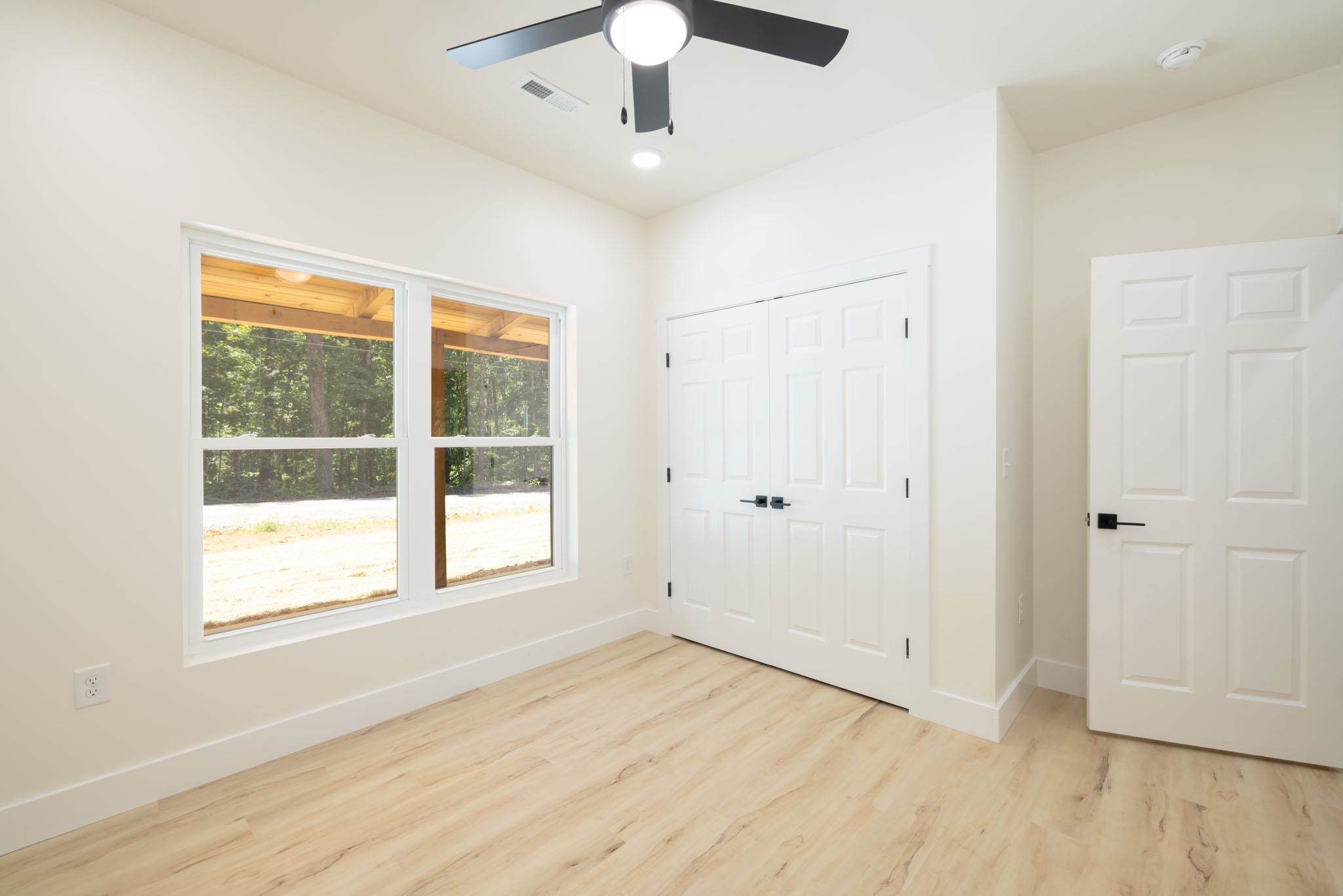 37 William Teague Lane Ramer, TN 38367 - Photo 31 of 39 Light-filled room featuring wood-finish flooring, a contemporary ceiling fan, and white trim