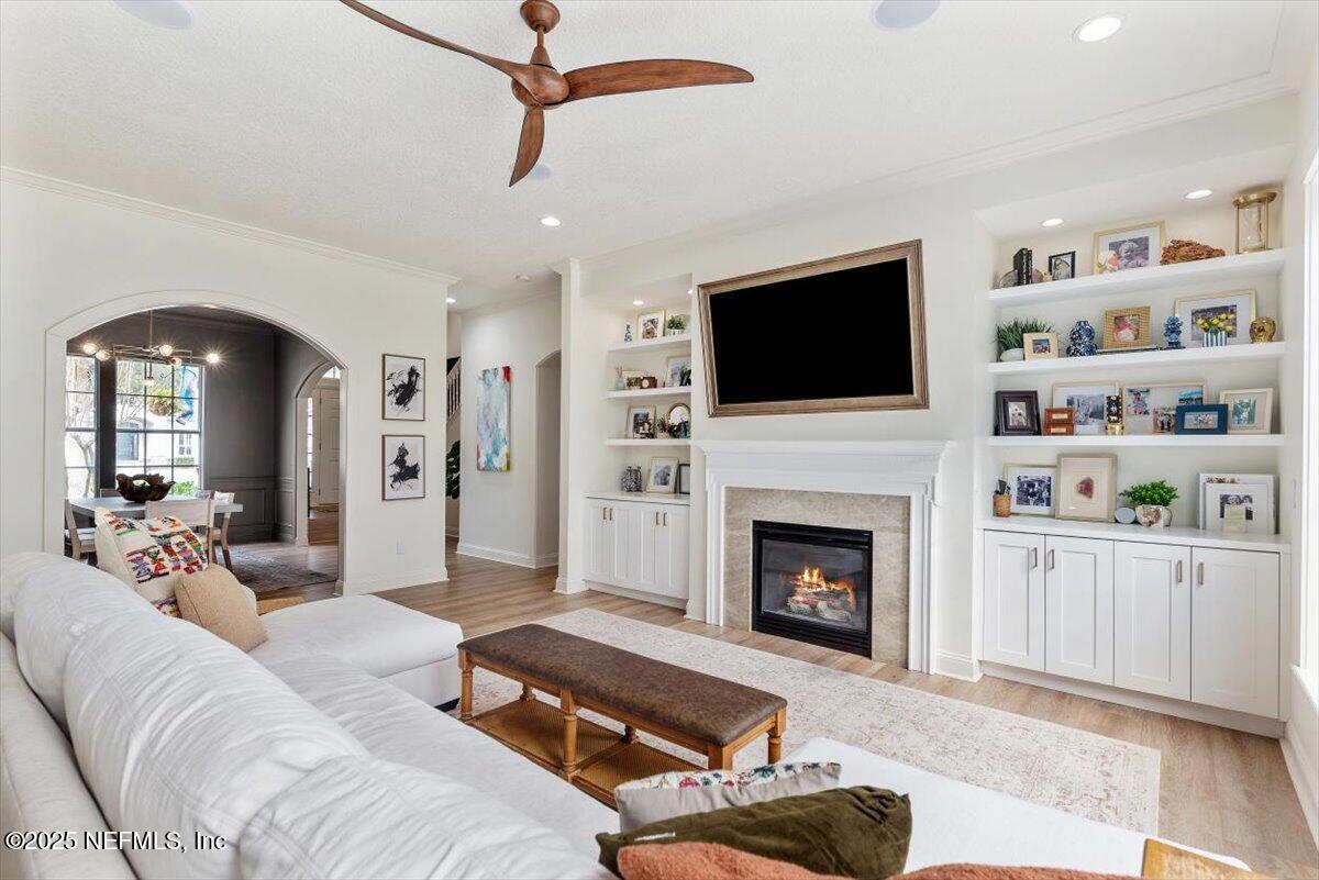 1047 Eagle Point Drive St. Augustine, FL 32092 - Photo 13 of 85 a living room with furniture a fireplace and a flat screen tv