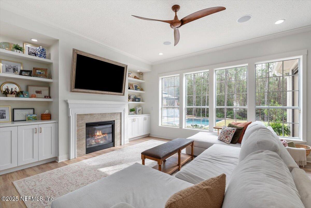 1047 Eagle Point Drive St. Augustine, FL 32092 - Photo 14 of 85 a living room with furniture a flat screen tv and a fireplace