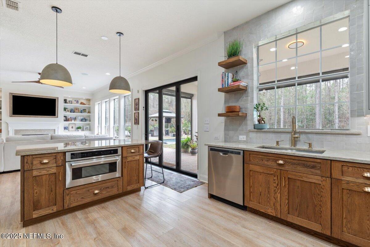 1047 Eagle Point Drive St. Augustine, FL 32092 - Photo 16 of 85 a kitchen with stainless steel appliances granite countertop a stove and a sink