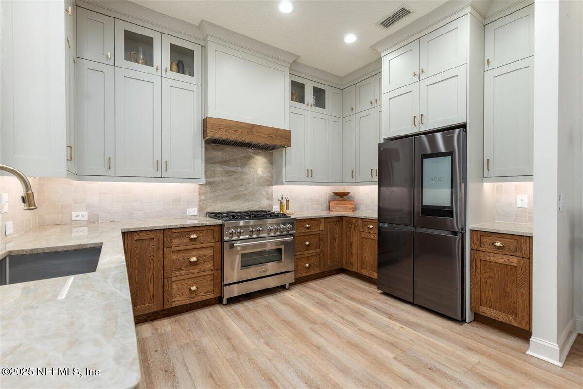 1047 Eagle Point Drive St. Augustine, FL 32092 - Photo 19 of 85 a kitchen with stainless steel appliances granite countertop a refrigerator and a stove