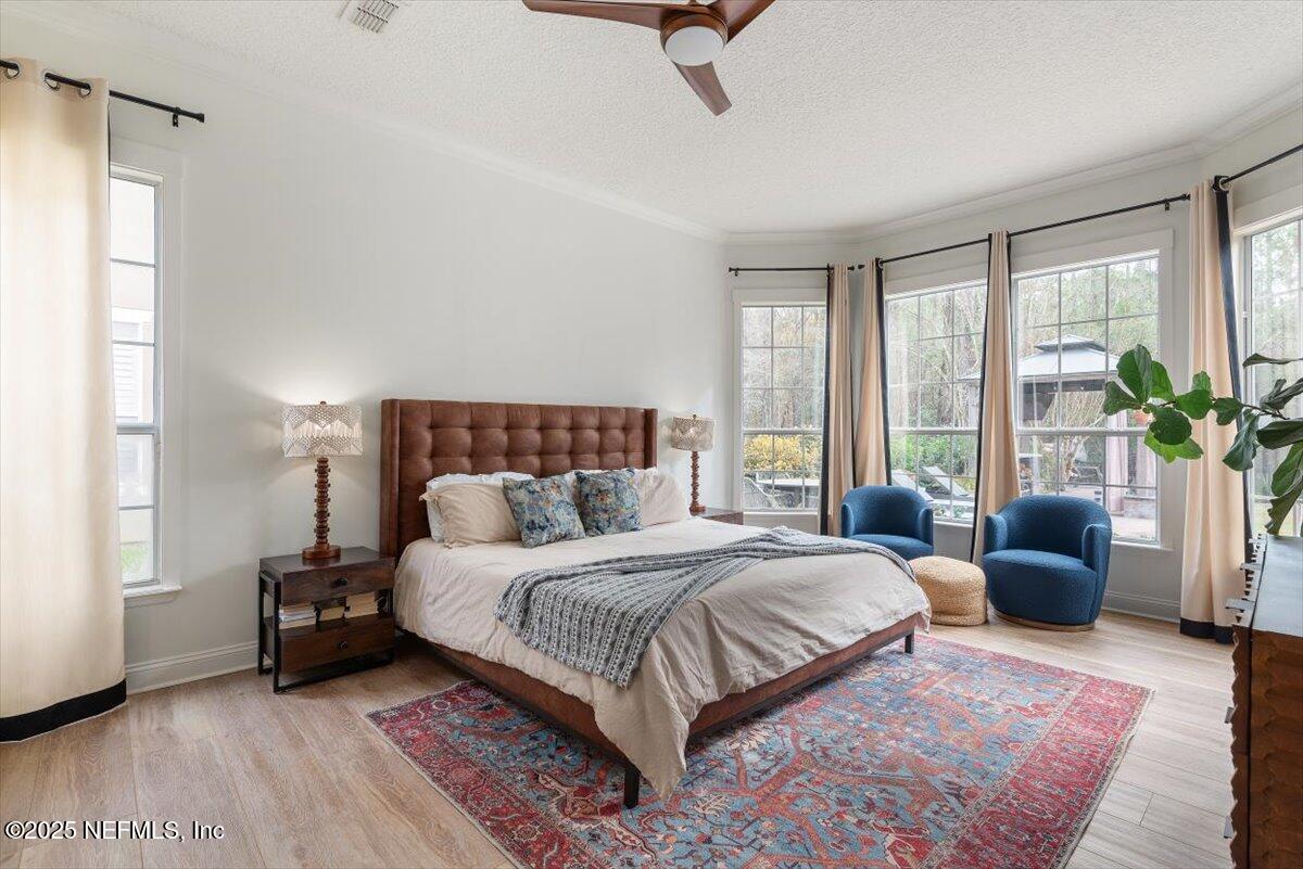 1047 Eagle Point Drive St. Augustine, FL 32092 - Photo 27 of 85 a bedroom with a large bed couch and a window