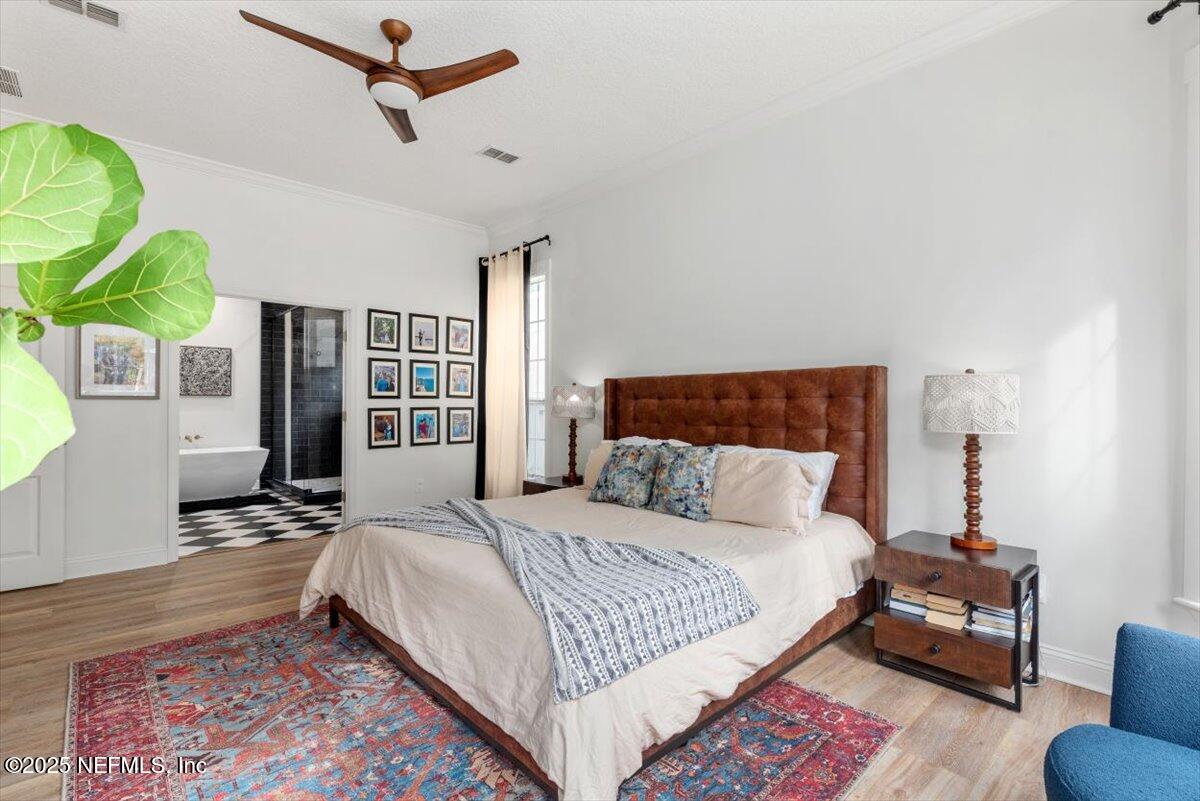 1047 Eagle Point Drive St. Augustine, FL 32092 - Photo 30 of 85 a bedroom with a bed a couch and a potted plant