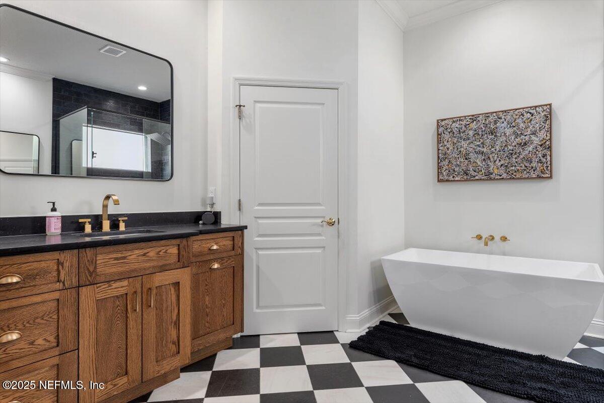 1047 Eagle Point Drive St. Augustine, FL 32092 - Photo 35 of 85 a bathroom with a sink and a mirror