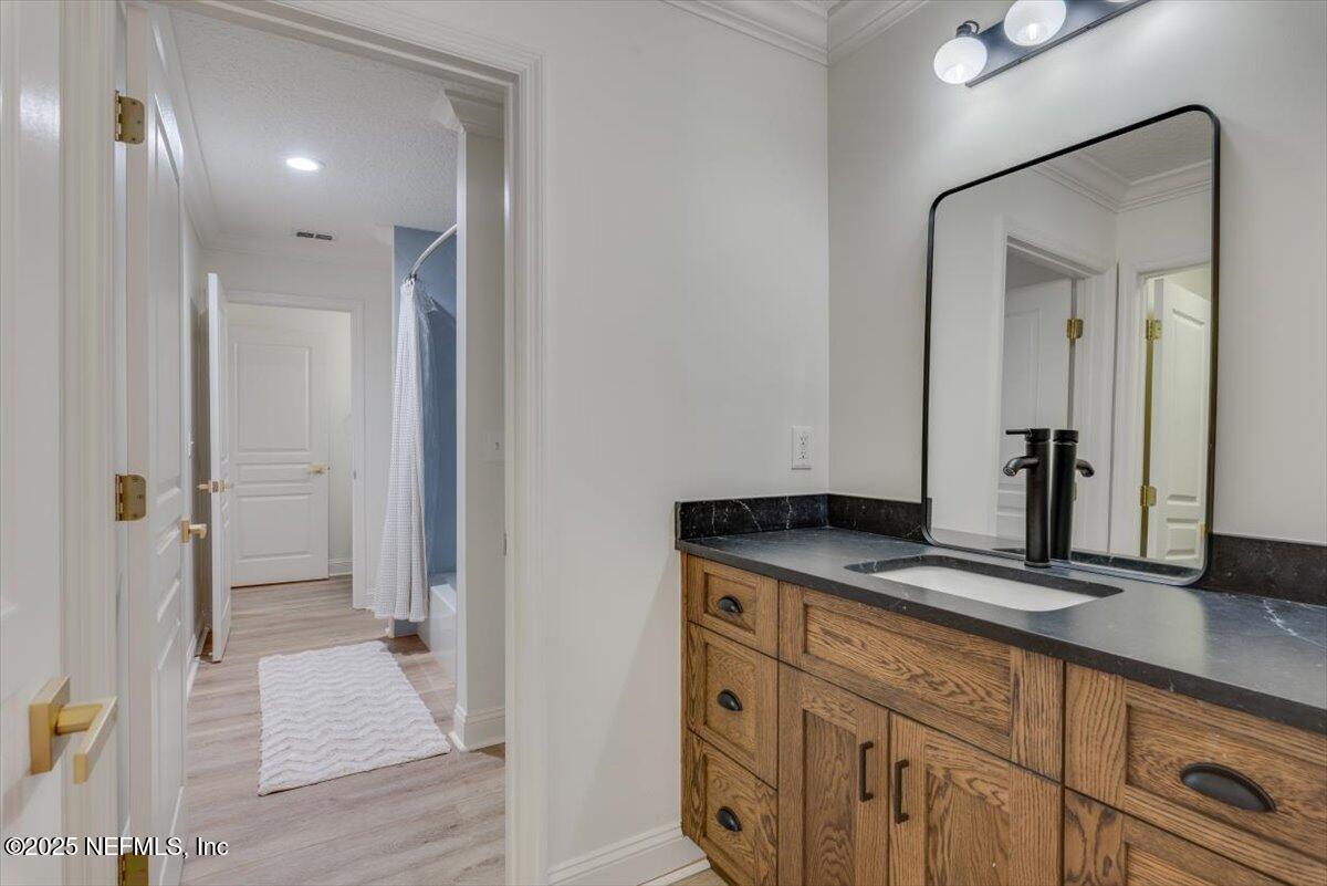 1047 Eagle Point Drive St. Augustine, FL 32092 - Photo 39 of 85 a bathroom with a granite countertop sink and a mirror