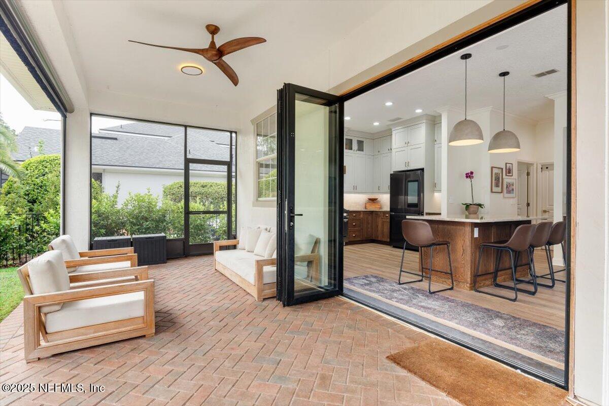 1047 Eagle Point Drive St. Augustine, FL 32092 - Photo 49 of 85 a living room with furniture and a floor to ceiling window