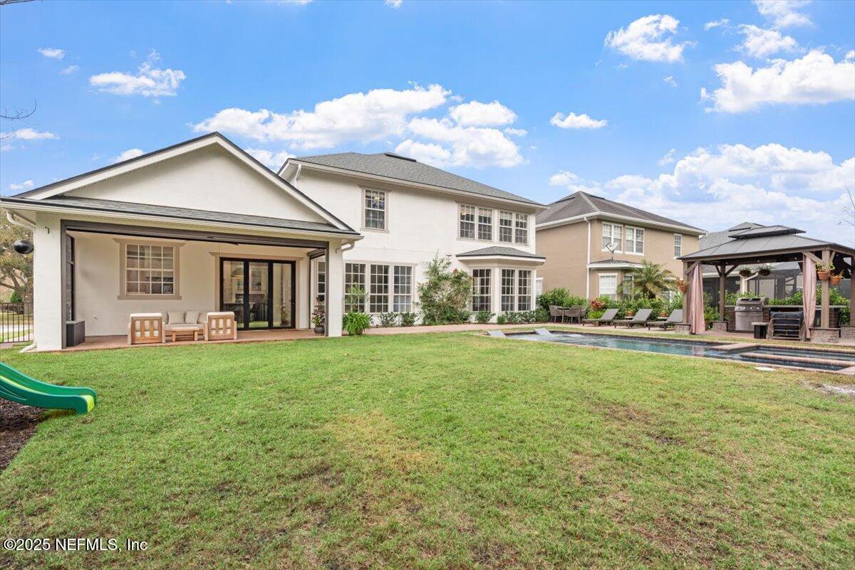 1047 Eagle Point Drive St. Augustine, FL 32092 - Photo 59 of 85 a view of a house with a yard porch and sitting area