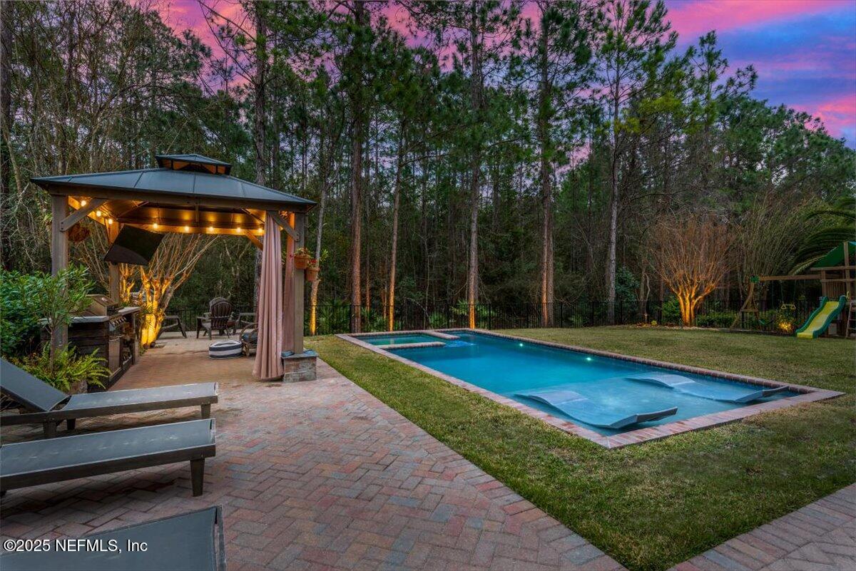 1047 Eagle Point Drive St. Augustine, FL 32092 - Photo 61 of 85 a view of swimming pool with lawn chairs and wooden fence
