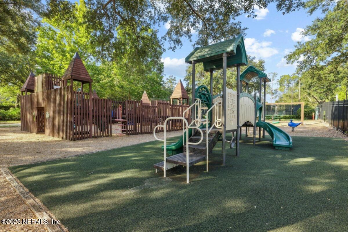 1047 Eagle Point Drive St. Augustine, FL 32092 - Photo 75 of 85 a wooden bench sitting in front of a building