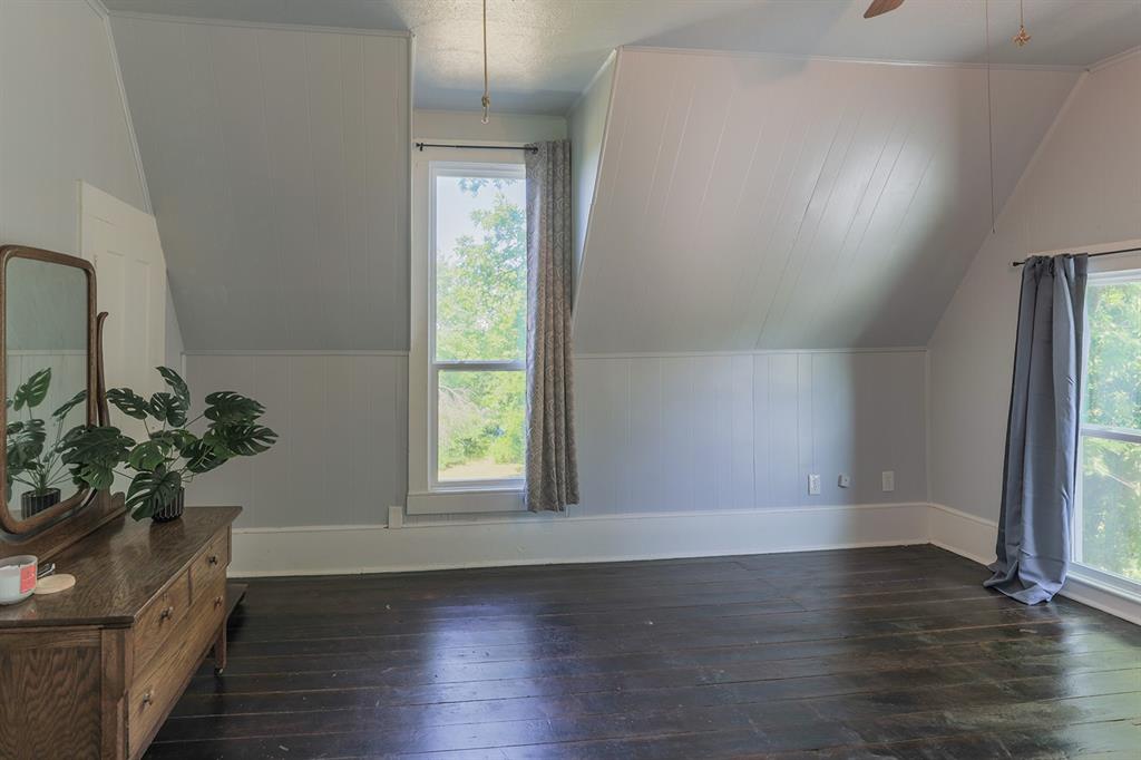 453 East Marshall Street Van Alstyne, TX 75495 - Photo 20 of 30 an empty room with wooden floor and windows
