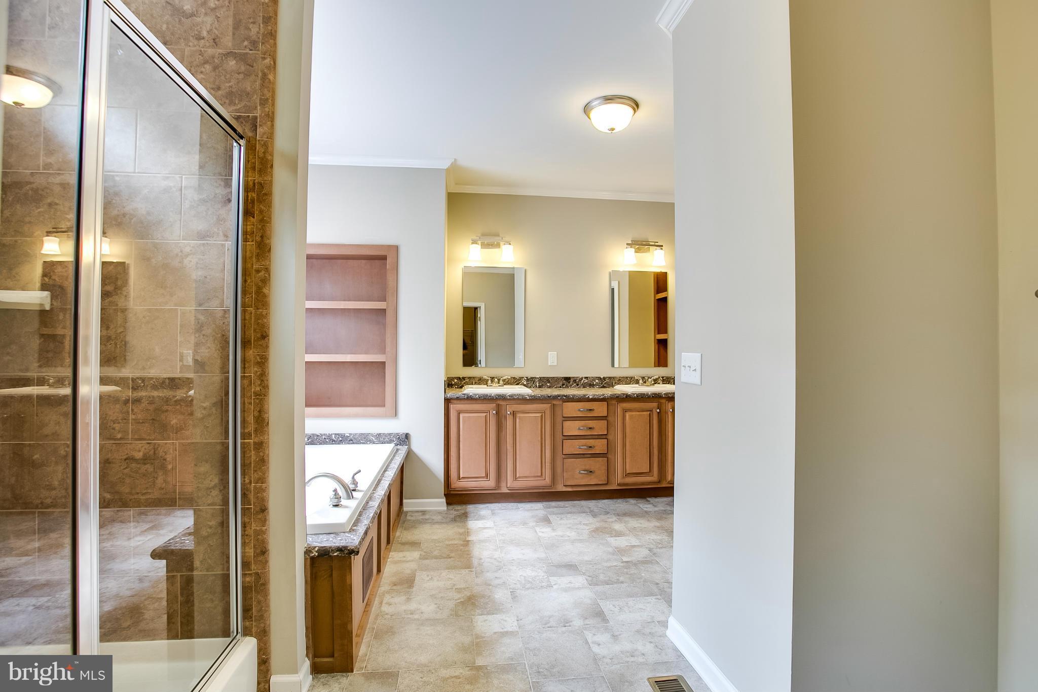 10421 Edenton Road Partlow, VA 22534 - Photo 15 of 18 a large bathroom with a glass door shower and sink