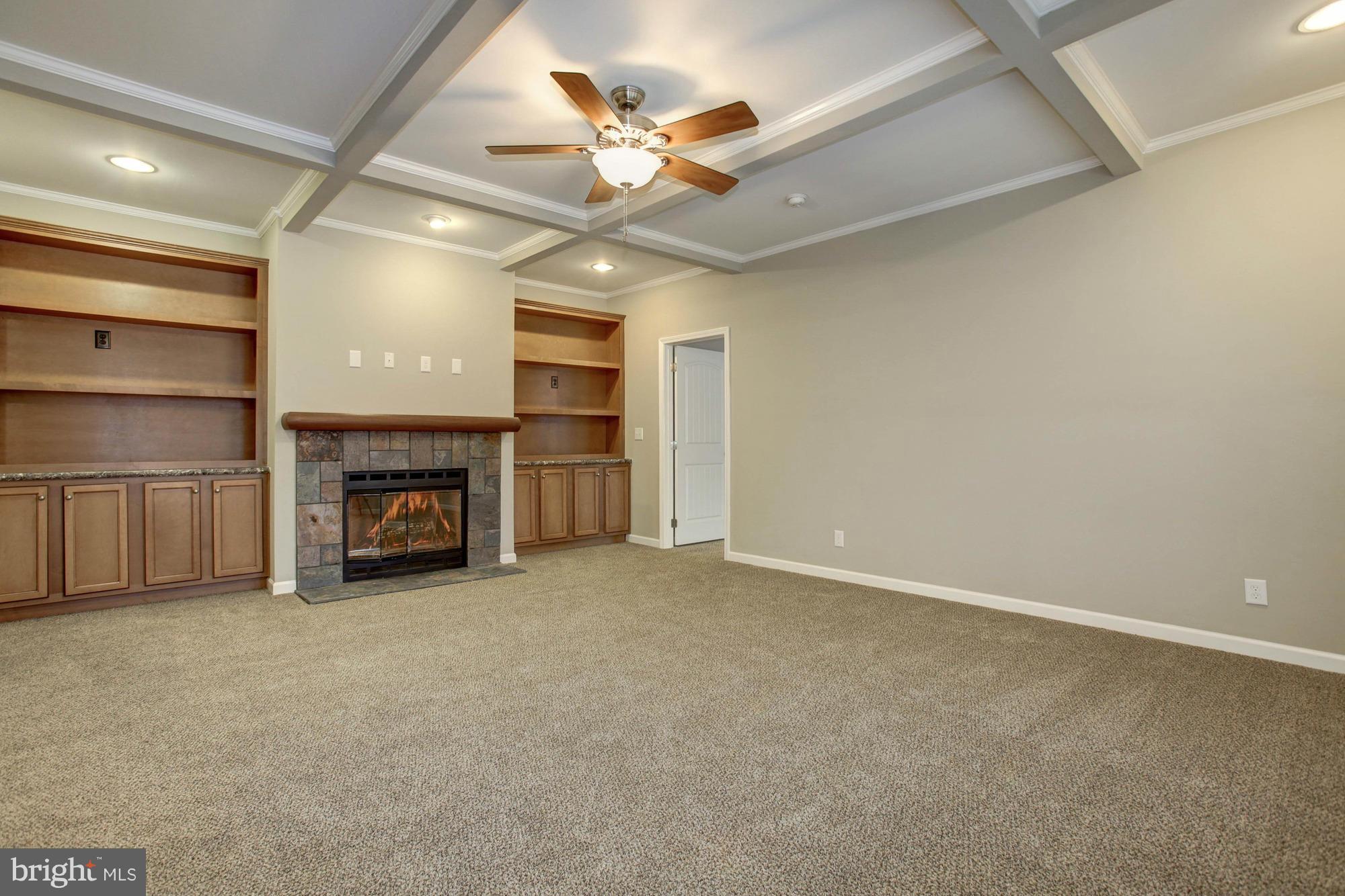 10421 Edenton Road Partlow, VA 22534 - Photo 4 of 18 an empty room with fireplace ceiling fan and windows