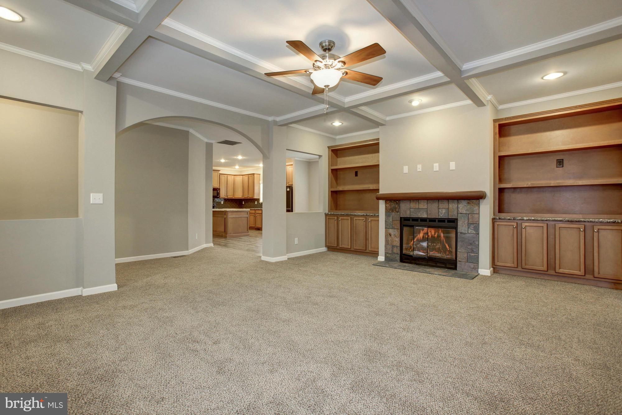 10421 Edenton Road Partlow, VA 22534 - Photo 5 of 18 an empty room with chandelier fan and fireplace