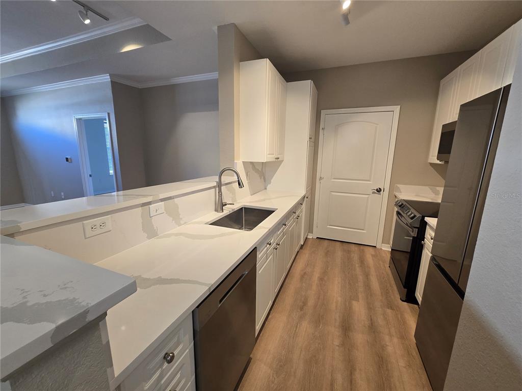4221 West Spruce Street, Unit 2420 Tampa, FL 33607 - Photo 11 of 33 a kitchen with a sink and a refrigerator