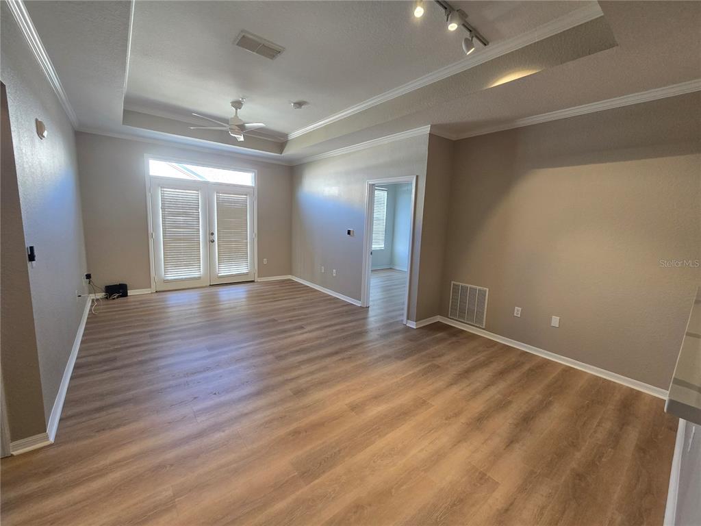 4221 West Spruce Street, Unit 2420 Tampa, FL 33607 - Photo 14 of 33 an empty room with wooden floor and windows