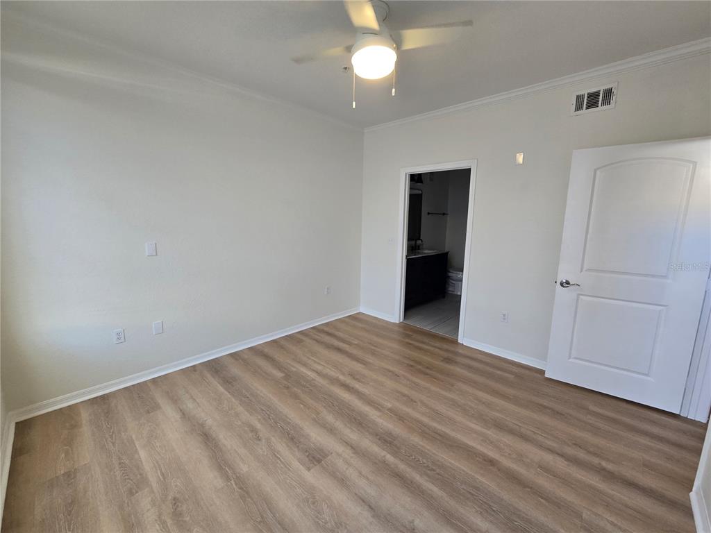 4221 West Spruce Street, Unit 2420 Tampa, FL 33607 - Photo 21 of 33 a view of an empty room with wooden floor
